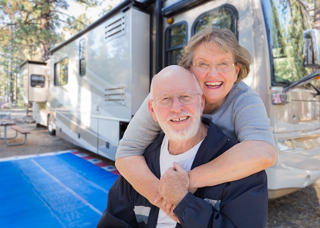 senior couple in front of rv