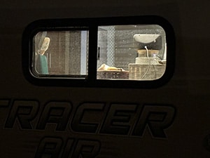 Rules of RV Life with Windows Curtains Open At Night